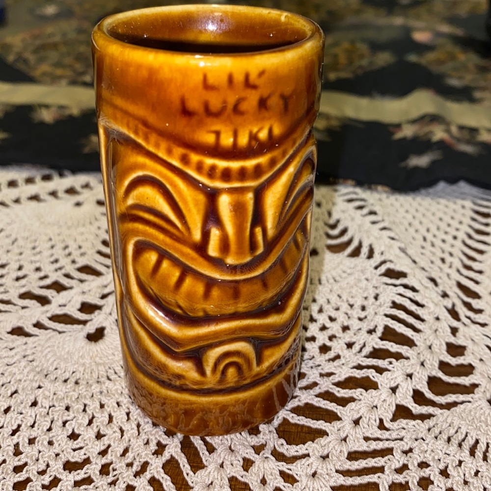 Tiki Shot Glass Marked “Lil’ Lucky Tiki” Above Front Face Tiki Farm ®️ Brand